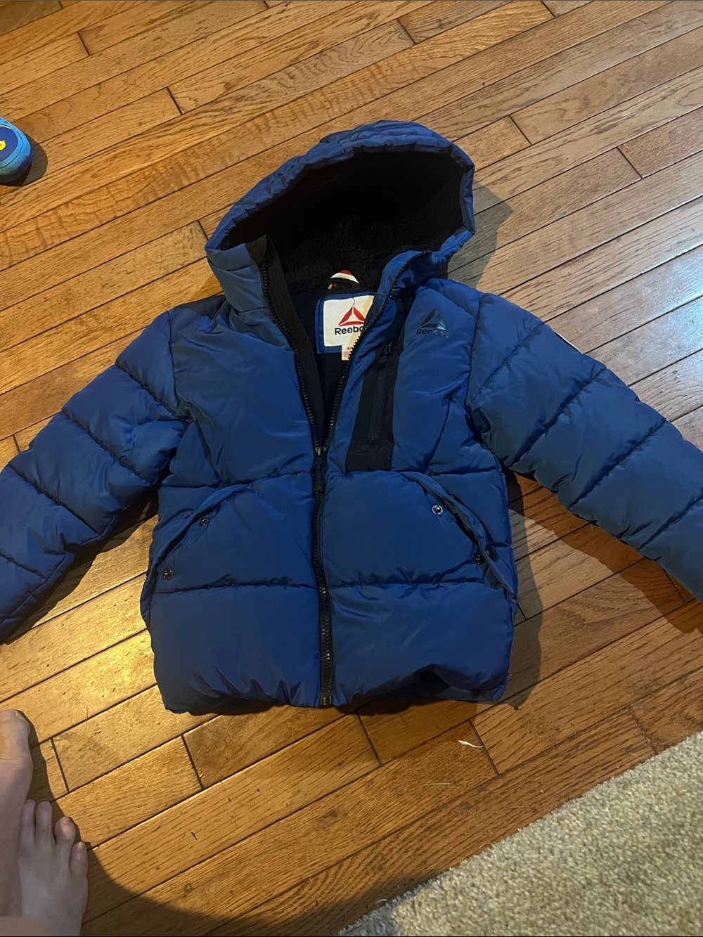 This is a blue Reebok toddler puffer jacket featuring a cozy hooded design 4/5